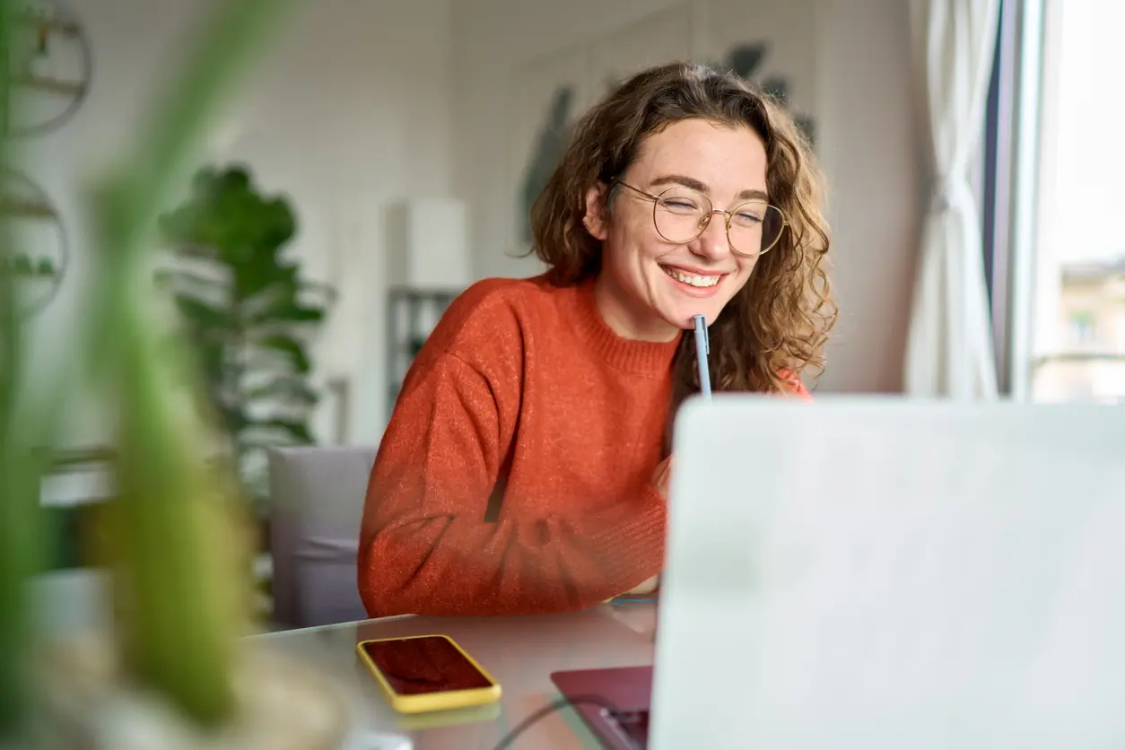 cheerful woman using her laptop