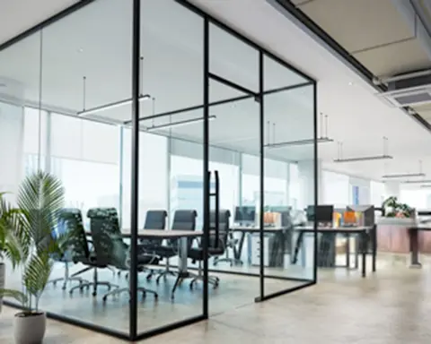 expansive office space with transparent glass walls and several chairs for seating